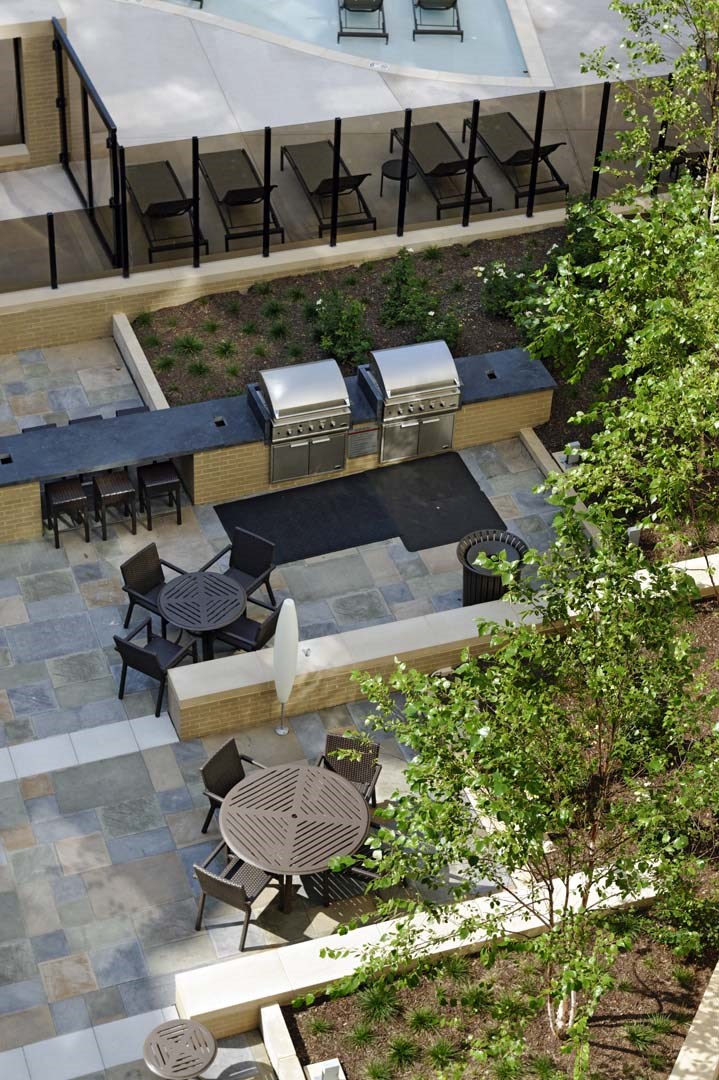 an aerial view of a courtyard with tables and benches