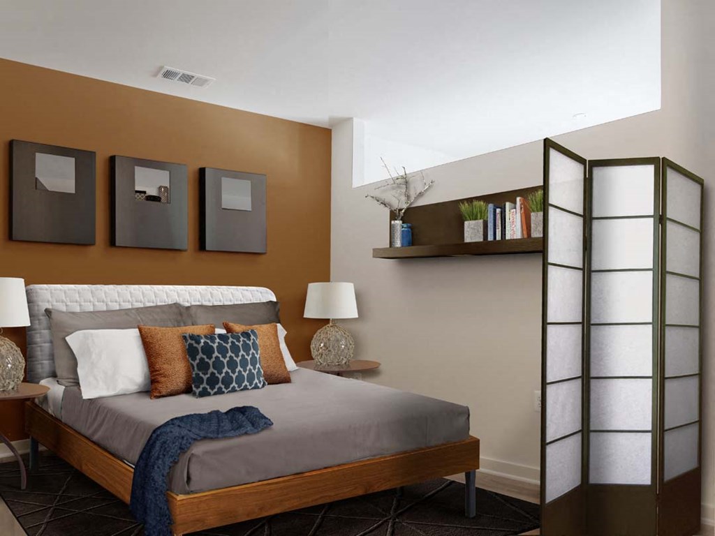 a bedroom with a bed and a mirror