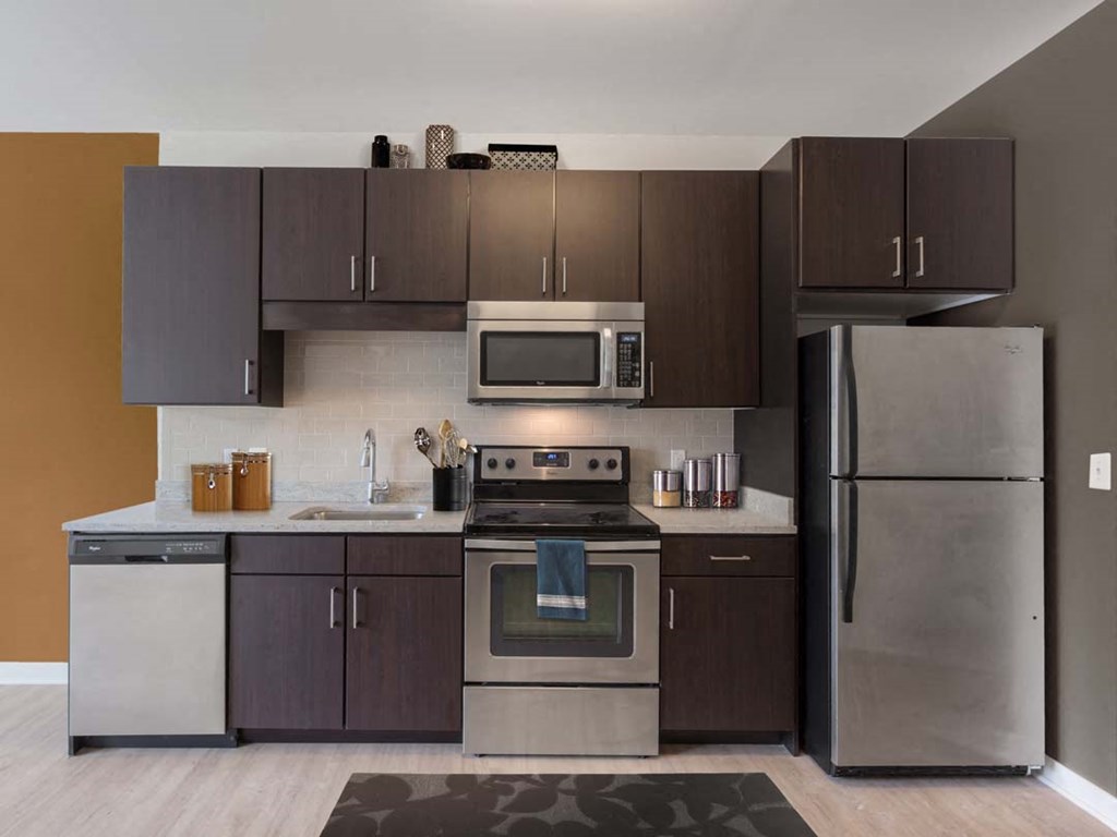 a kitchen with stainless steel appliances and wooden cabinets