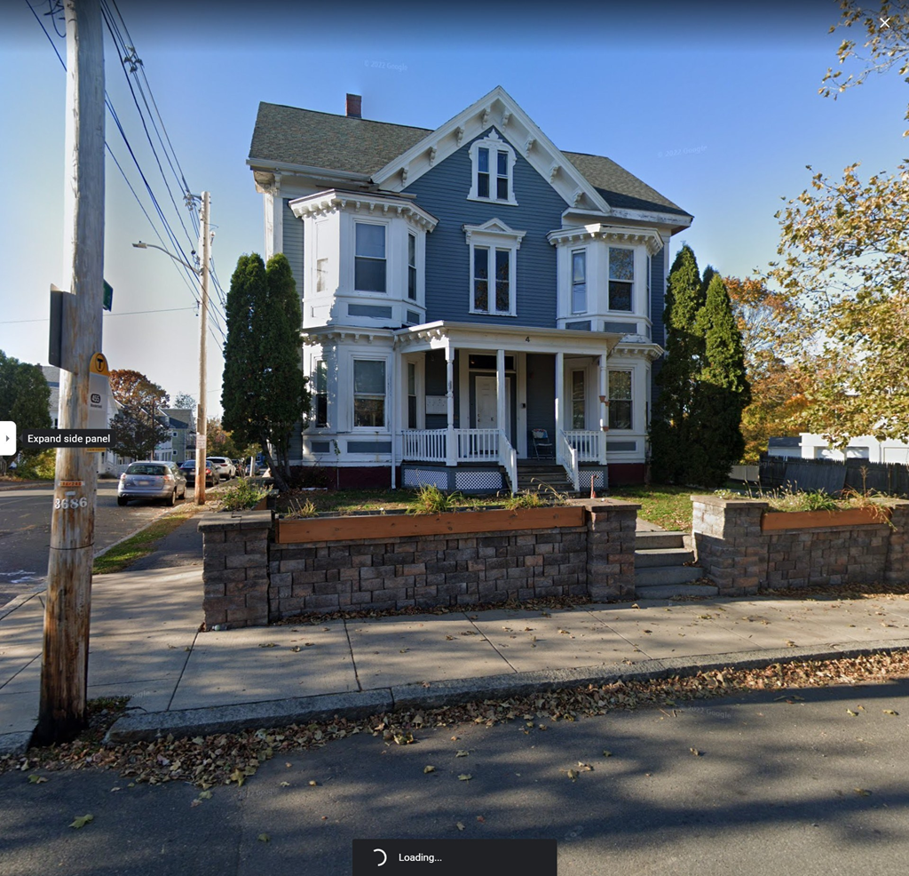 a blue house on the corner of a street