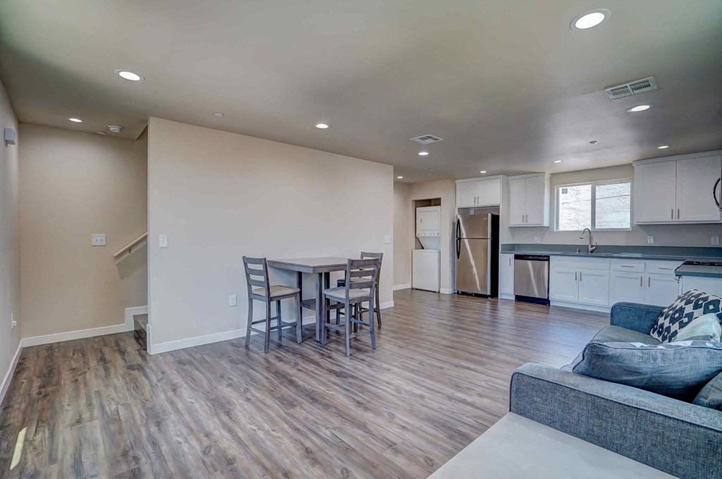 a living room and kitchen with a table and chairs