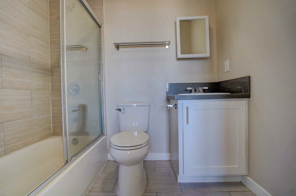 a bathroom with a toilet and a shower