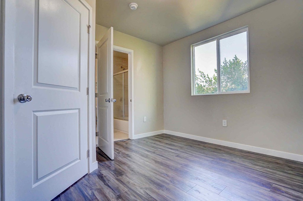 an empty room with a door and a window