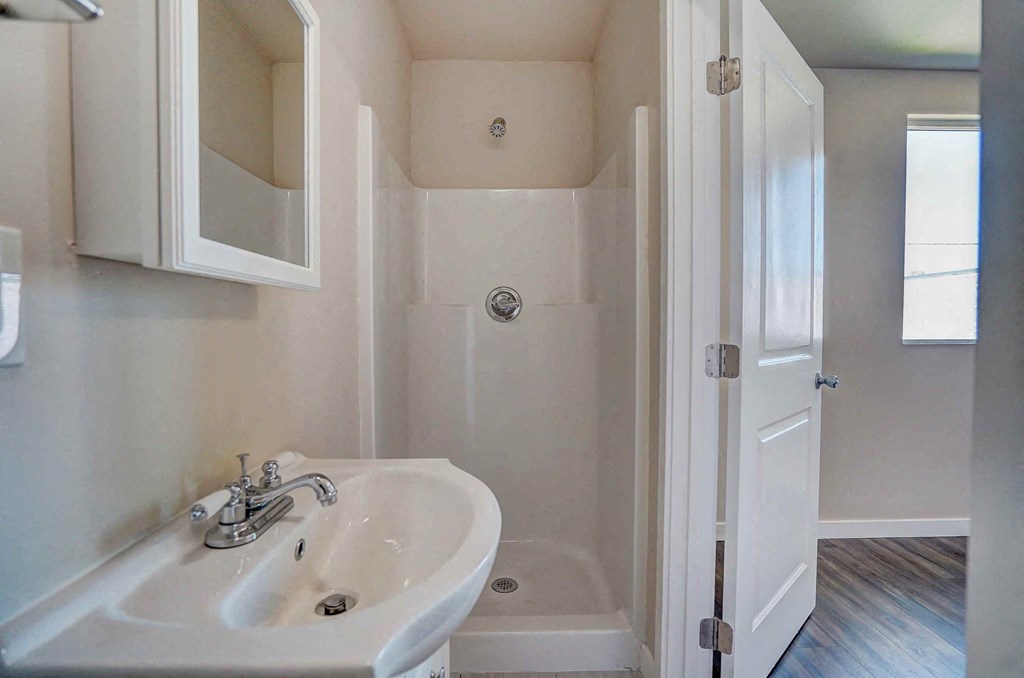 a bathroom with a sink and a shower in it