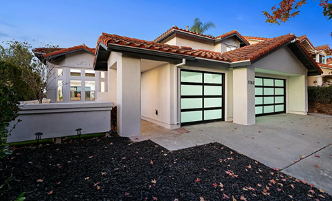 A house with a red tile roof and a garage door.