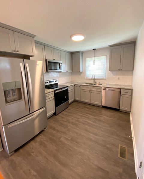 a kitchen with stainless steel appliances and white cabinets