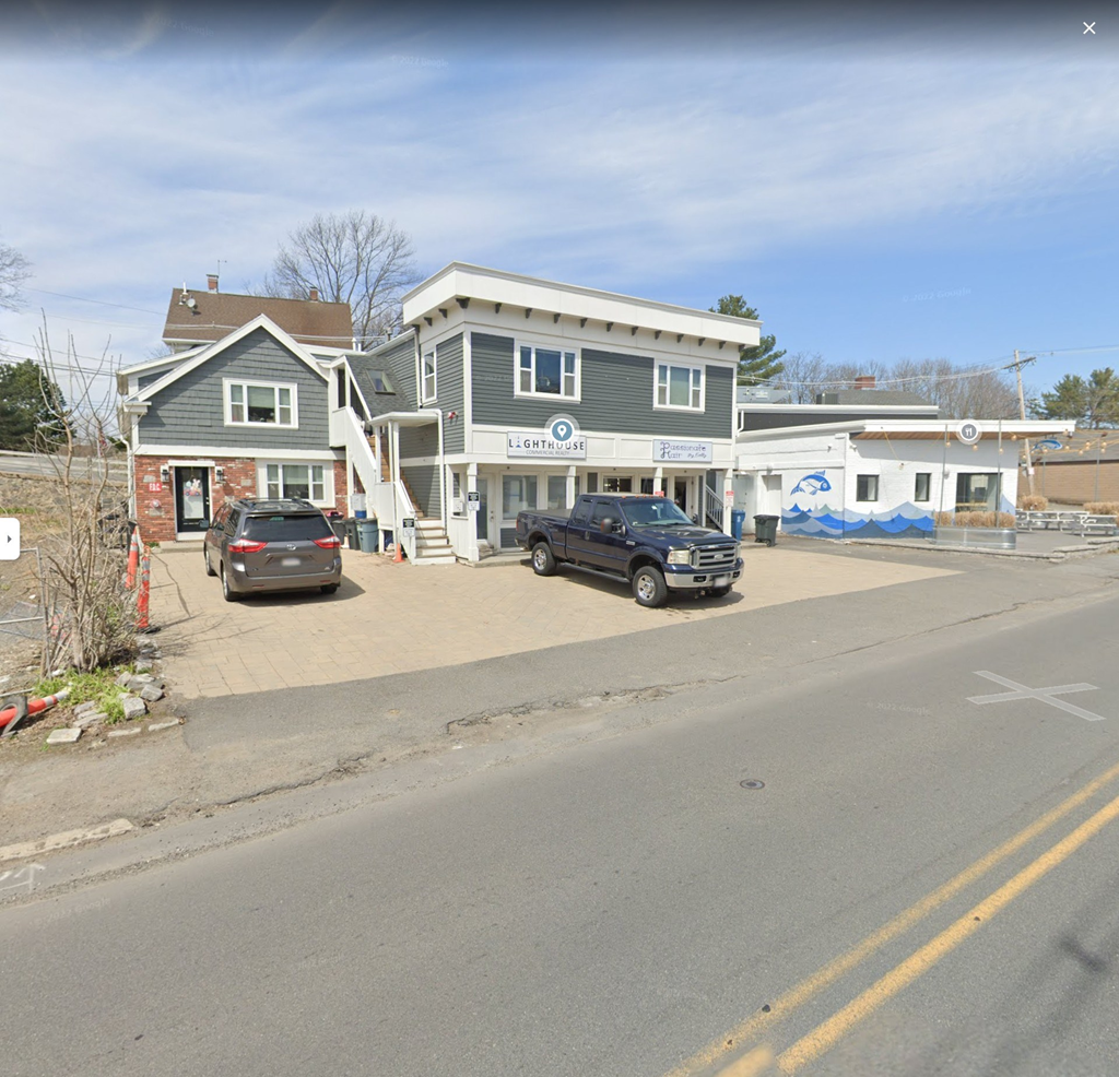 a car is parked in front of a house on a street