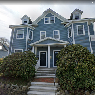 a blue house with white trim and a porch