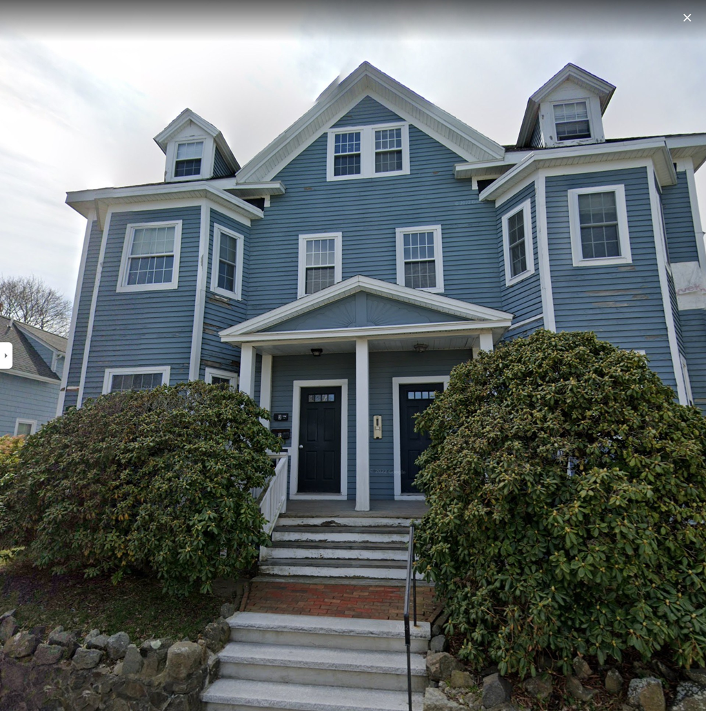 a blue house with white trim and a porch