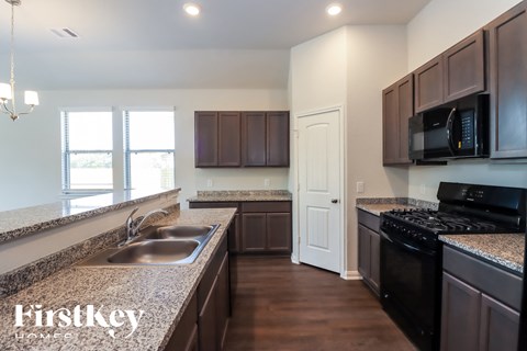 A kitchen with brown cabinets and a sink.