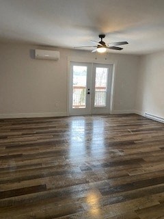 an empty living room with a ceiling fan and a door