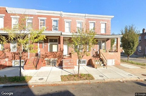 a brick building with a sidewalk in front of it
