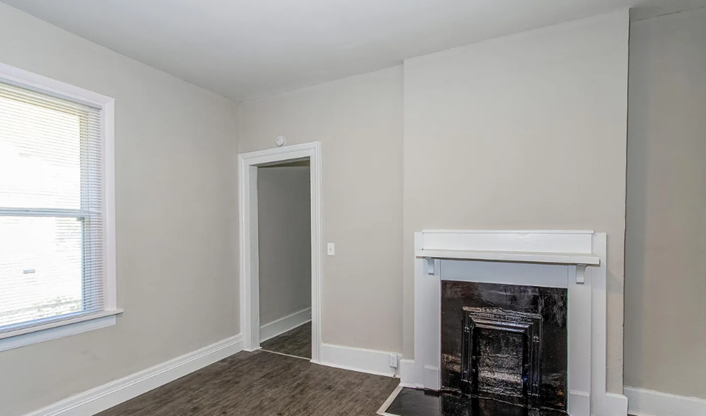 a living room with a fireplace and a window