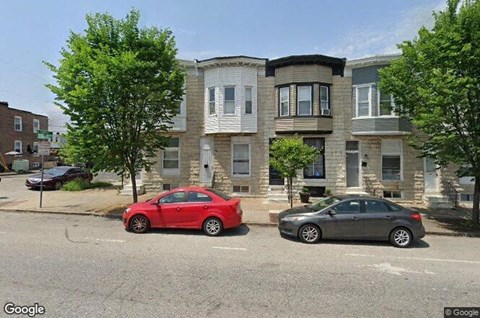 two cars parked in front of an apartment building