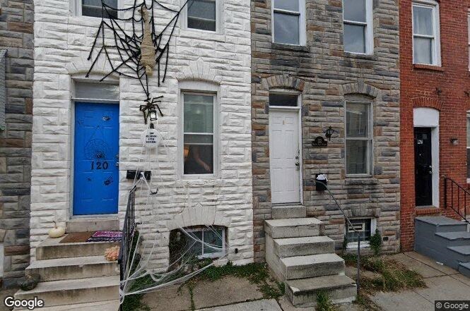 a white brick house with a blue door