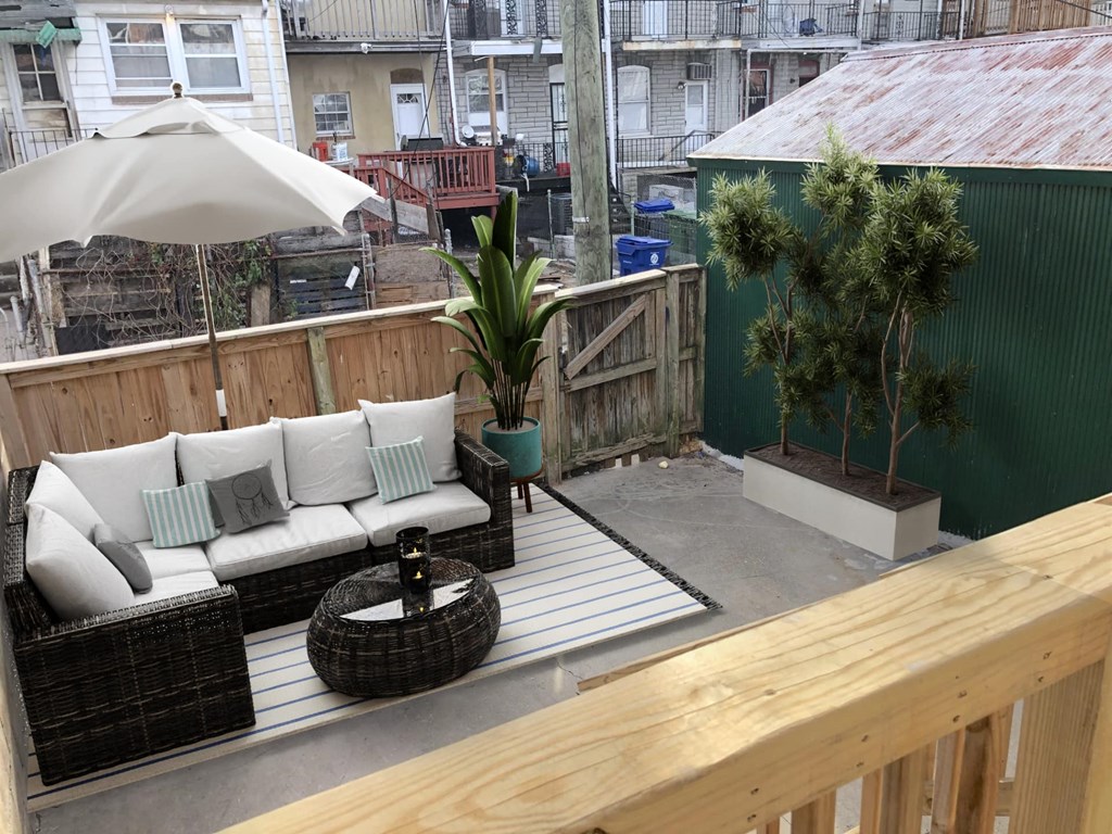 a wooden deck with a couch and a table