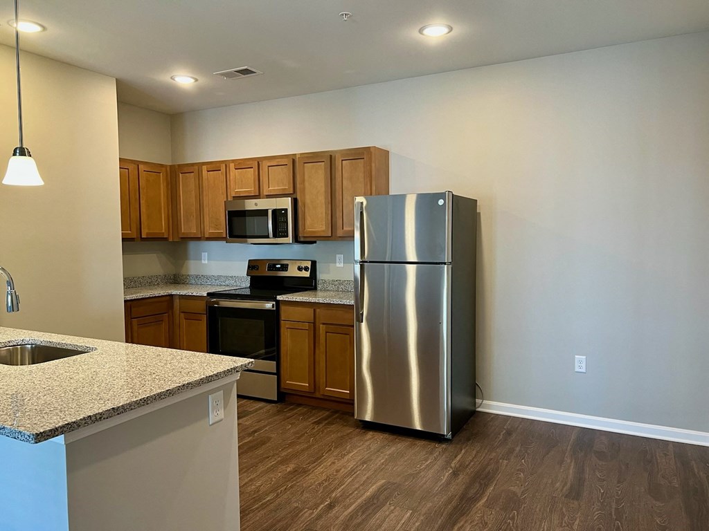 a kitchen with stainless steel appliances and granite counter tops