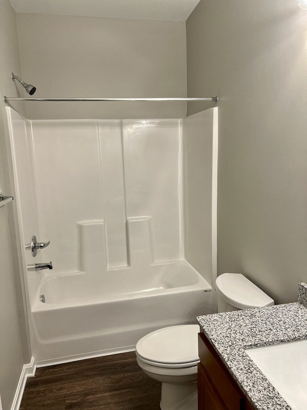 a bathroom with a shower and a toilet and a sink