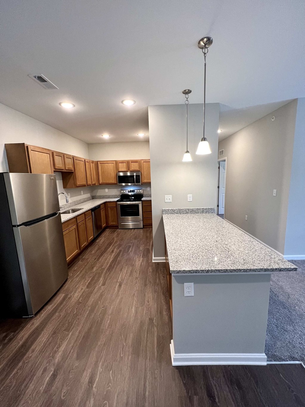 a kitchen with stainless steel appliances and granite counter tops