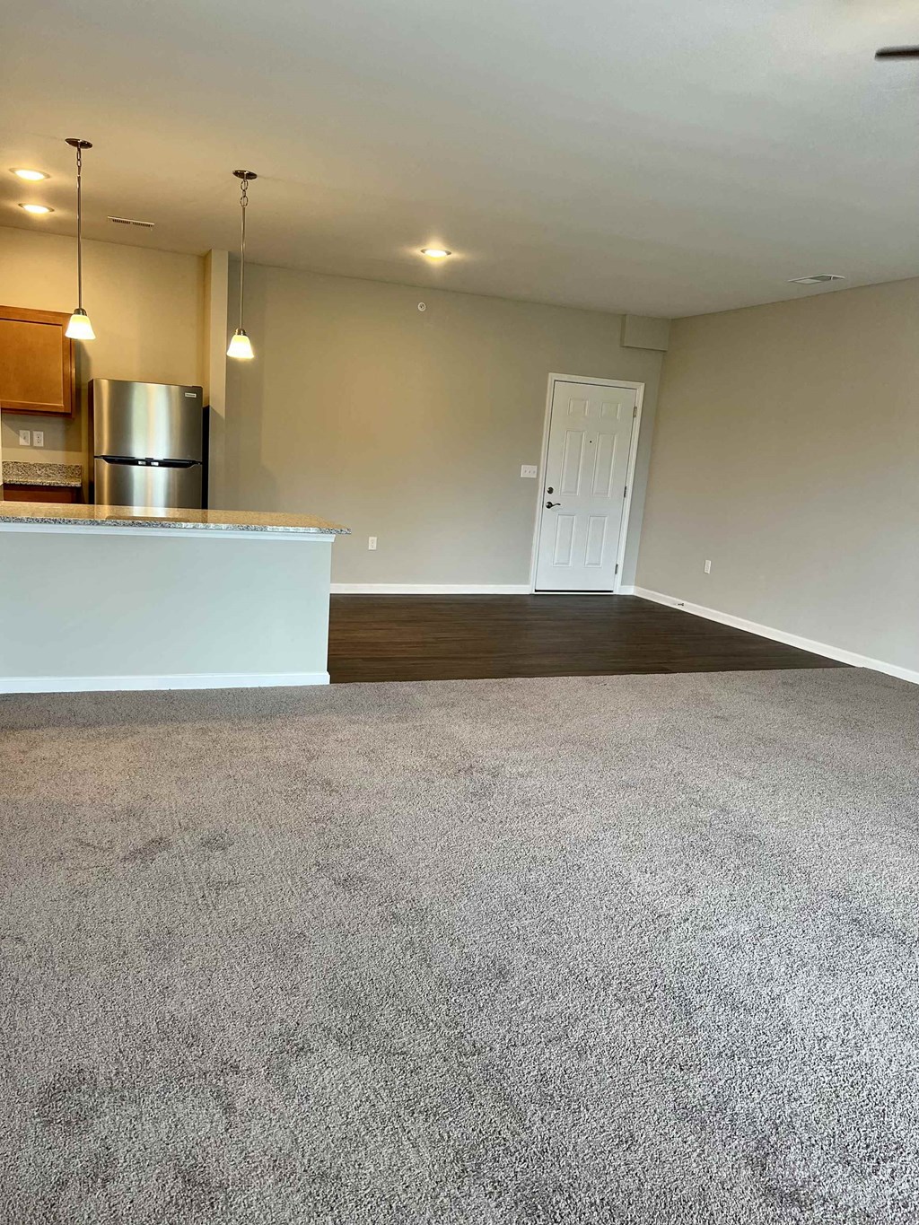 an empty living room and kitchen in a house