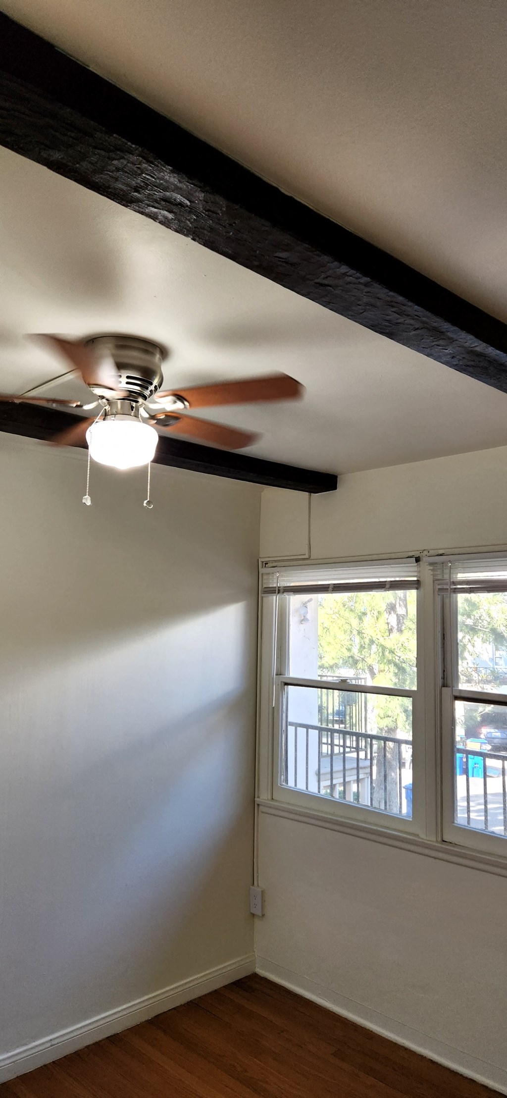 a bedroom with a ceiling fan and a window
