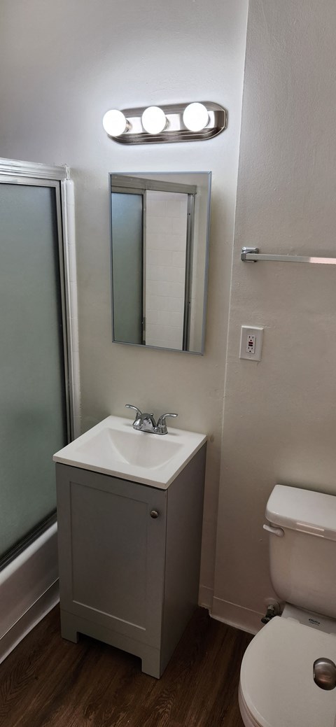 a small bathroom with a sink toilet and a mirror