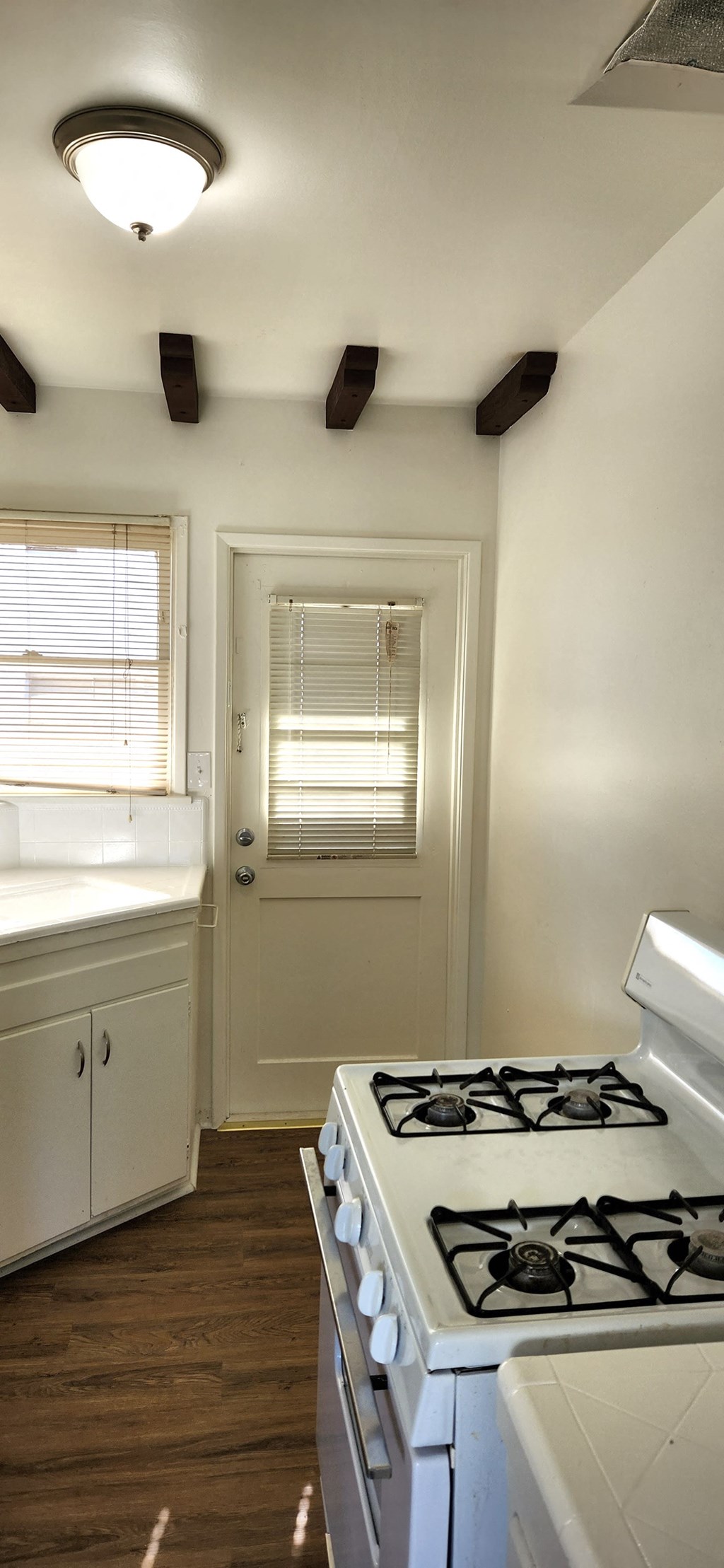an empty kitchen with a stove and a door