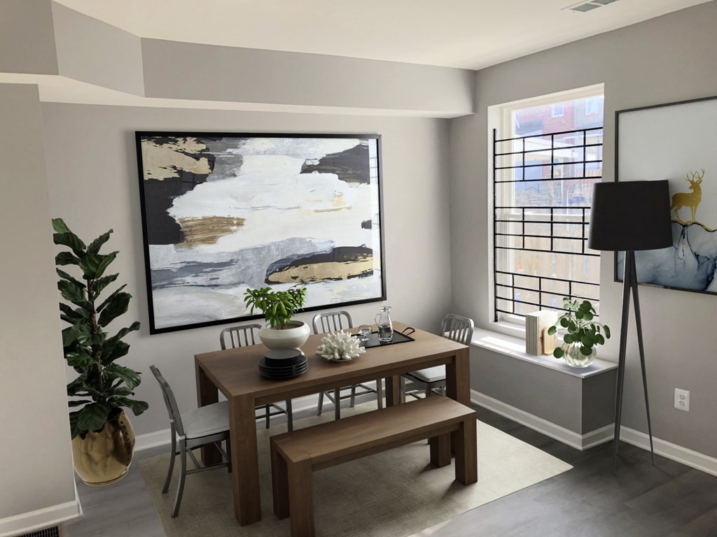 a dining room with a table and chairs and a painting on the wall