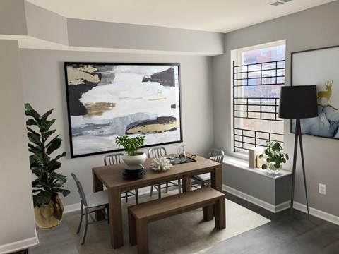 a dining room with a table and chairs and a painting on the wall
