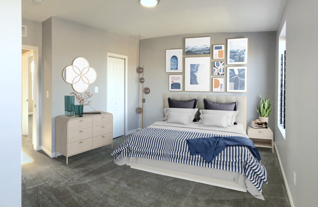 a bedroom with a bed and pictures on the wall