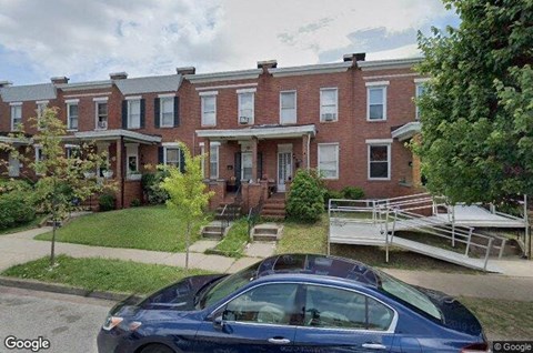 a car parked in front of a brick building