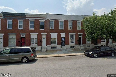 a red brick building with cars parked in front of it
