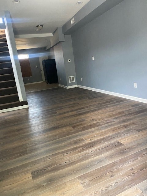 a living room with a hard wood floor and a staircase