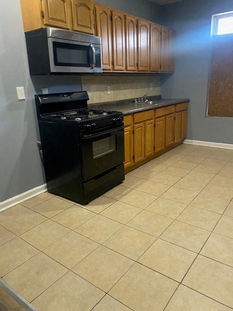 a small kitchen with a stove and a microwave