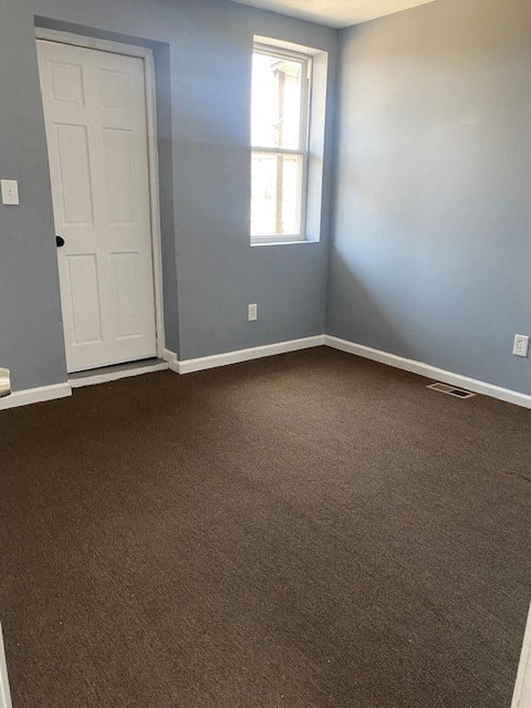 an empty room with blue walls and a white door