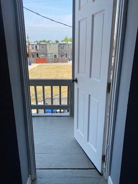 a white door is open to a balcony