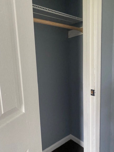 a small closet with a white door and blue walls