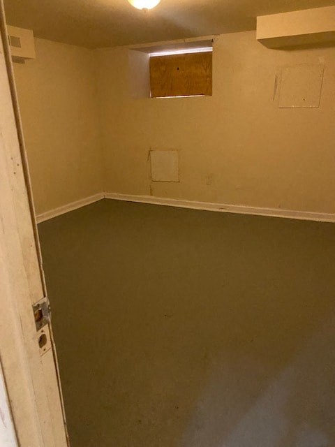 an empty room with an open door and a dirty floor