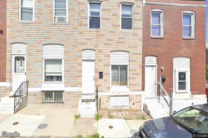 a brick building with a car parked in front of it