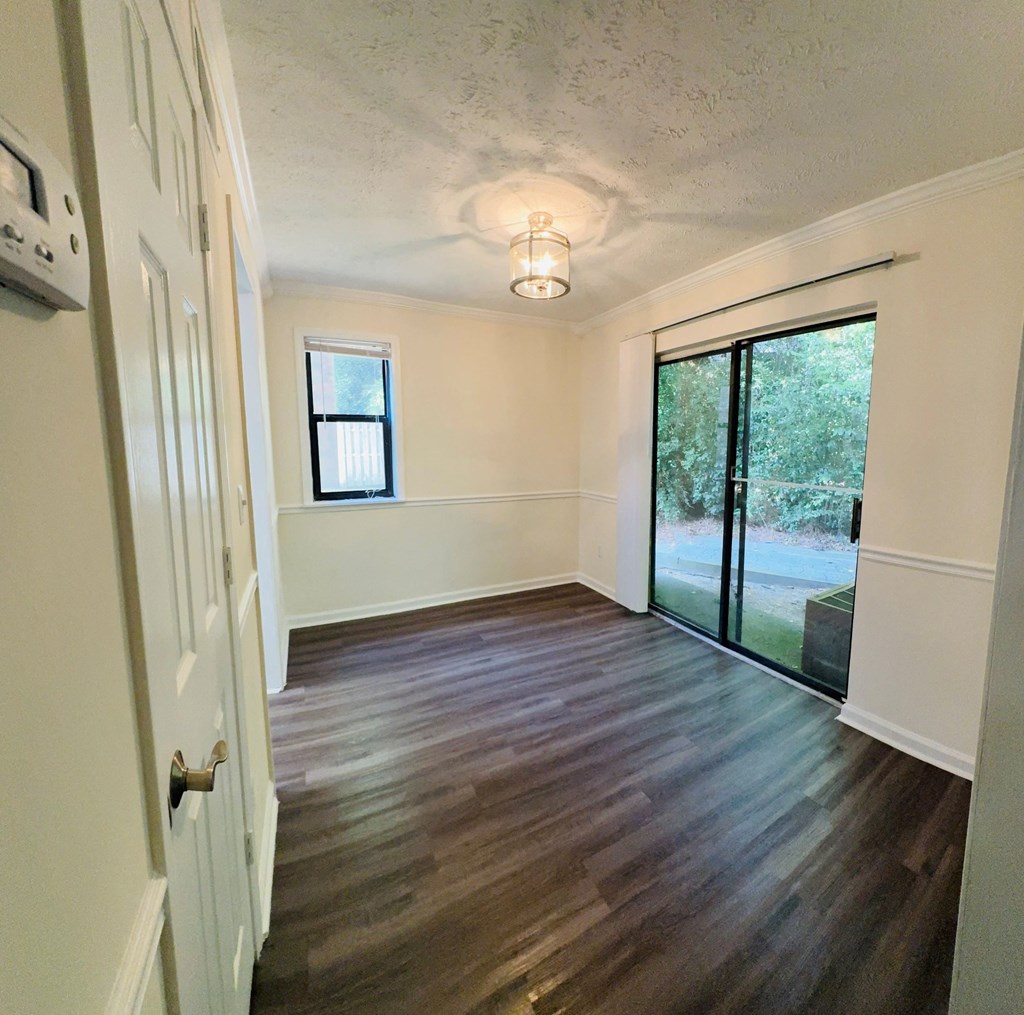 A room with a sliding glass door and a window.