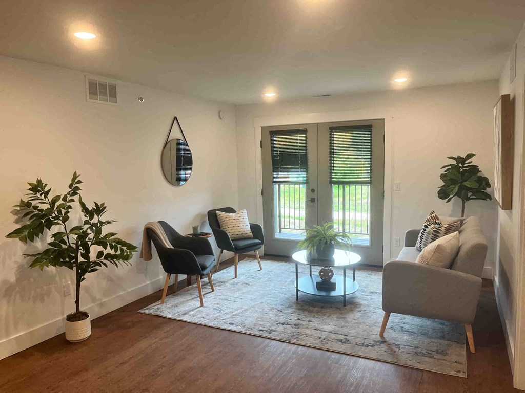 a living room with a couch and chairs and a coffee table
