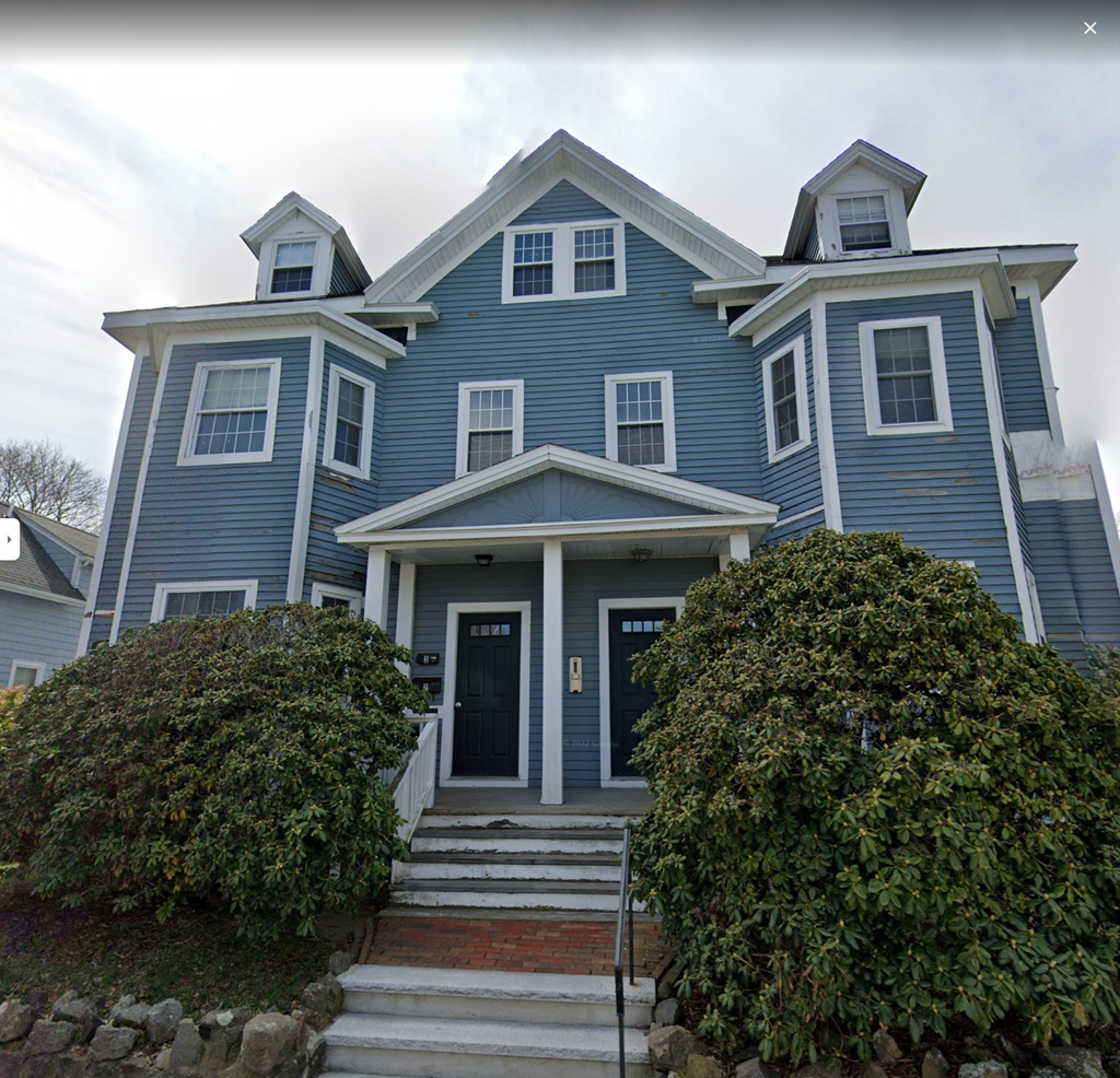 a blue house with two dormers on top of it