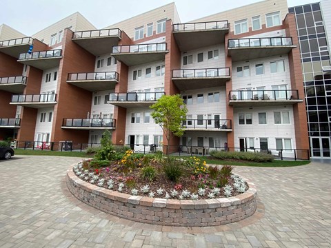an apartment building with a courtyard in front of it