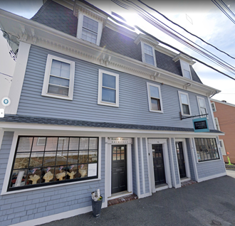 a blue and white building with a store in the front