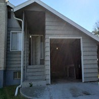 the front of a house with a garage door