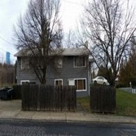 a gray house on the side of a street