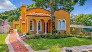 an orange house with a yard and a sidewalk