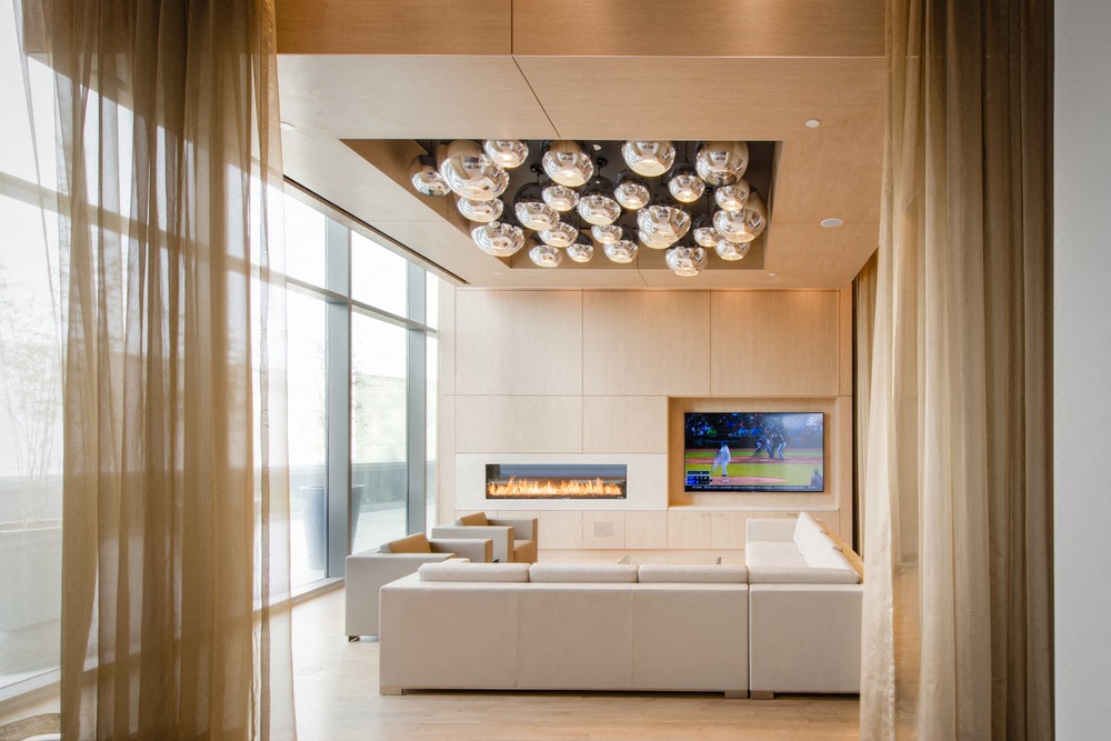 a large living room with a white couch and a fireplace