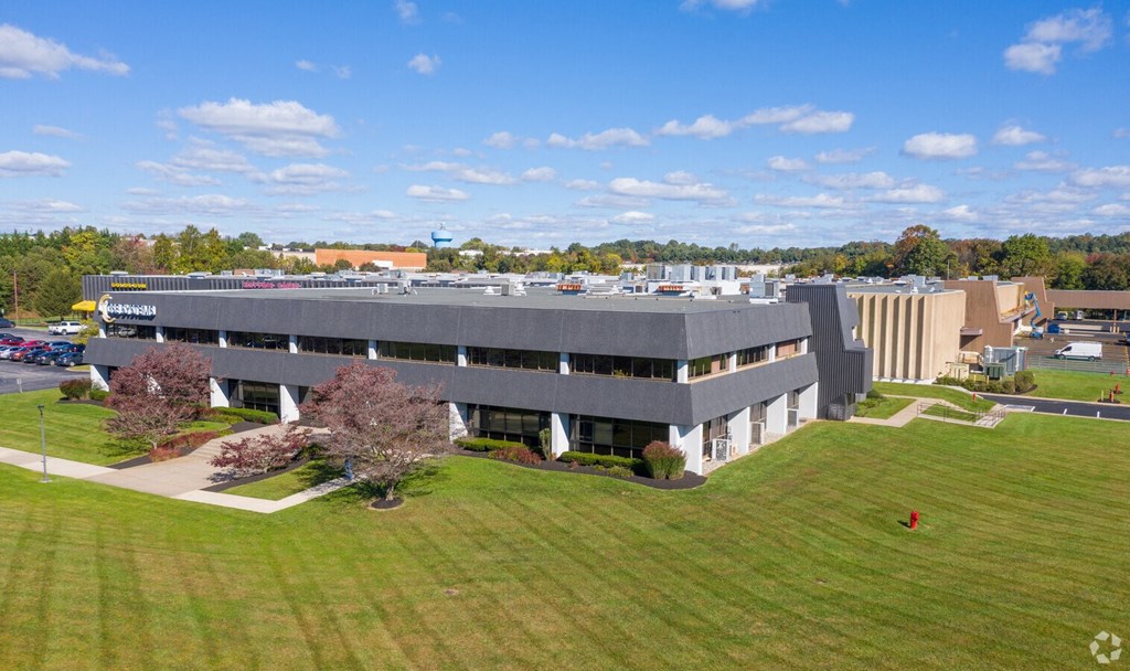 an aerial view of an office building with a green lawn