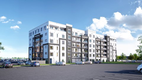 A large white building with a parking lot in front of it.